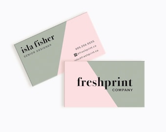 May include: A business card with a green and pink colour scheme. The text on the card reads "isla fisher, senior designer" and "freshprint company". The card also includes contact information, including a phone number, email address, and social media handle.