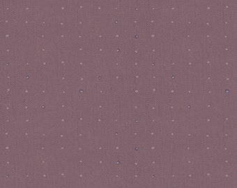May include: Close-up of a mauve fabric with a dotted pattern. The fabric has a textured appearance, with small, evenly spaced white and blue dots. A ruler with inch measurements is at the bottom, showing the fabric's scale.