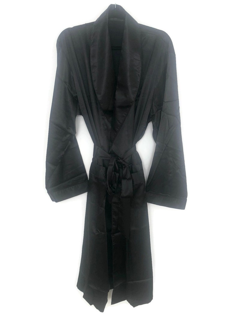 May include: A black satin robe with a shawl collar and a tie belt.