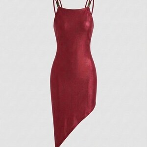 May include: A sleeveless, metallic dark red mini dress with a high neckline and thin spaghetti straps. The garment features a fitted silhouette and an asymmetrical hemline that angles downward to a point on the left side of the dress.