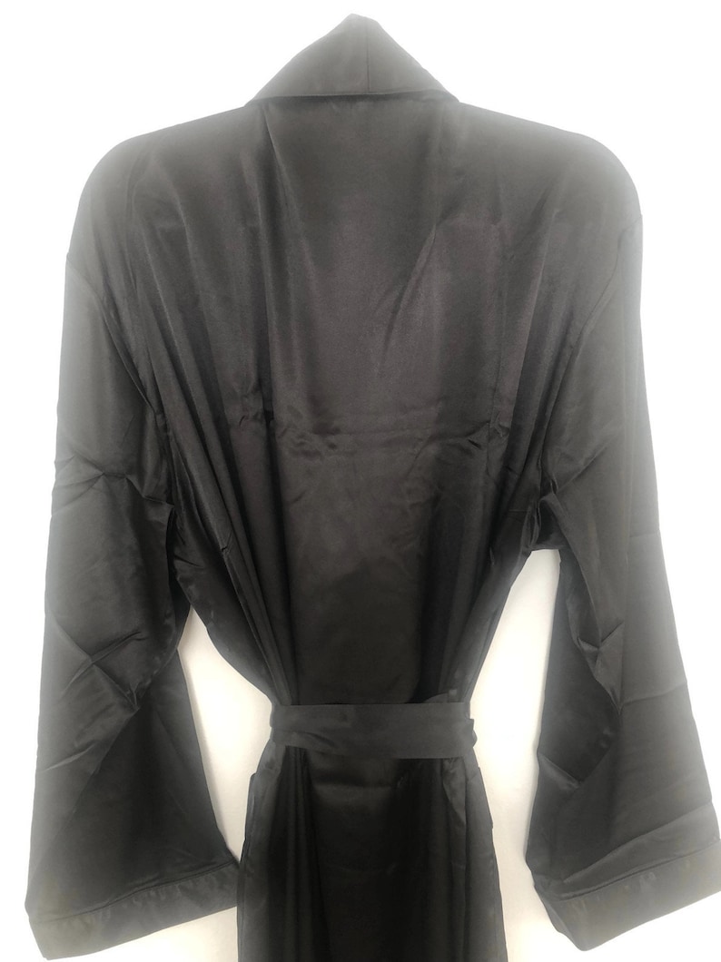 May include: A black satin robe with long sleeves and a tie belt.