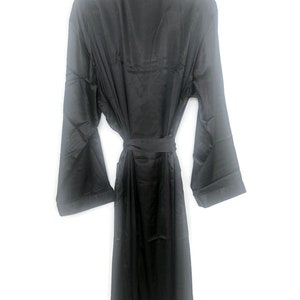May include: A black satin robe with long sleeves and a tie belt.