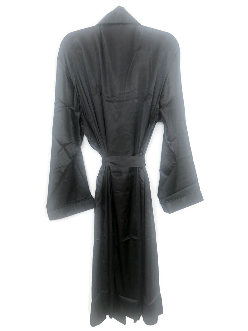 May include: A black satin robe with long sleeves and a tie belt.