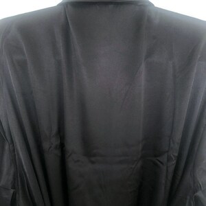 May include: A black satin robe with a collar and long sleeves.