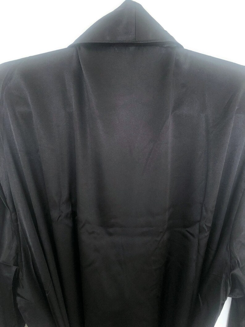 May include: A black satin robe with a collar and long sleeves.