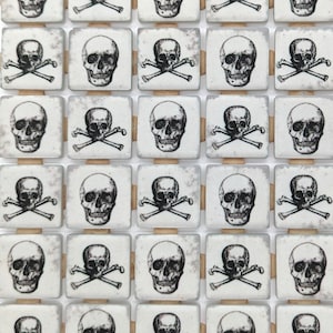 May include: A collection of square tiles, each featuring a black and white skull and crossbones design. The tiles are arranged in a grid pattern, with a distressed, vintage aesthetic. The skulls are detailed, and the overall theme is gothic or pirate-inspired.