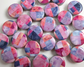 May include: A collection of 20 round ceramic tiles with a geometric pattern in shades of pink, purple, and blue. The tiles are approximately 1 inch in diameter.