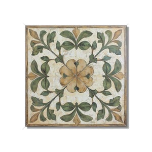 May include: A square tile with a floral design. The tile is white with a brown and green floral pattern. The center of the tile features a four-leaf clover design.