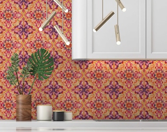 May include: A kitchen backsplash with a colorful patterned tile design. The tiles are a mix of orange, yellow, pink, and purple. The backsplash is behind a white countertop and cabinets.
