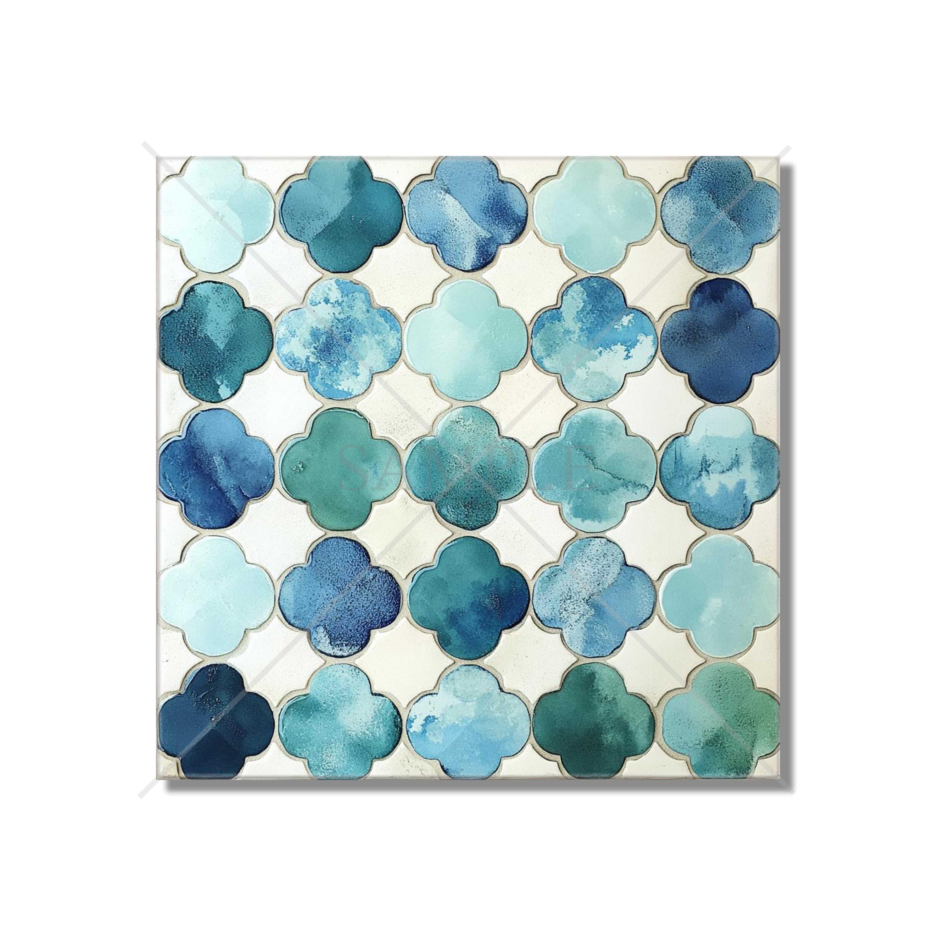 May include: Square tile with a repeating pattern of blue and teal quatrefoil shapes. The shapes have a watercolor effect, with variations in color and texture. The background is a light cream color.