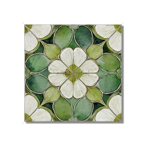 May include: Square tile with a floral design. The tile features a central white flower surrounded by green leaves and petals. The design is symmetrical, with a watercolor effect. The color palette includes shades of white and green.