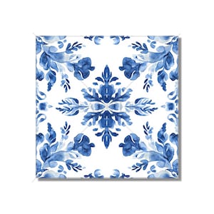 May include: A white tile with a blue and white floral pattern. The pattern is symmetrical and features intricate details.