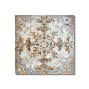 May include: Square decorative tile with a detailed floral pattern in shades of beige, brown, and cream. The design features a central flower surrounded by ornate, symmetrical leaf and scroll elements, set against a textured, aged background.