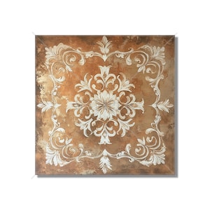 May include: Square decorative wall art featuring a detailed white floral design on a brown and gold textured background. The artwork has a vintage, ornate style with symmetrical patterns and a central floral motif.
