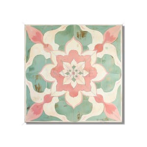 May include: Square artwork featuring a symmetrical floral design in shades of pink, cream, and teal. The design has a distressed, vintage look with a white border. The artwork is likely a decorative piece for home decor.