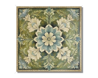 Op de afbeelding: Een vierkant, ingelijst kunstwerk met een bloemmotief met een centrale blauwe bloem omringd door witte en groene bladeren. Het kunstwerk heeft een gouden lijst.