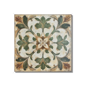 May include: A square tile with a decorative floral pattern in shades of green, brown, and white. The design features intricate leaves and a central flower.