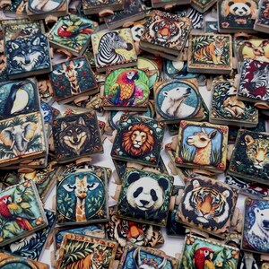 May include: A collection of square wooden tiles featuring colorful illustrations of various animals including tigers, pandas, lions, wolves, zebras, giraffes, parrots, and polar bears, arranged in a dense, overlapping pile with visible wooden edges.