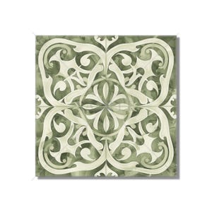 May include: A square tile with a white floral pattern on a green background. The pattern is intricate and symmetrical, with a central flower surrounded by swirling leaves.