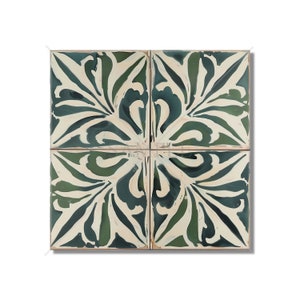 May include: Four square ceramic tiles with a green and white floral pattern. The tiles are arranged in a square pattern, with the floral design centered in each tile.