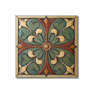 May include: A square ceramic tile with a decorative design featuring a cross-shaped pattern with intricate floral motifs in shades of green, brown, and cream.