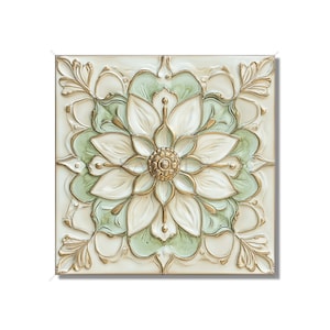 May include: Square, off-white wall art with a raised floral design. The flower has white petals, light green accents, and a gold center. Gold trim outlines the flower and surrounding leaves.