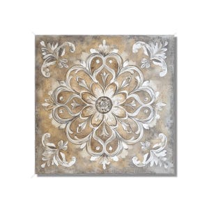 May include: Square wall art featuring a detailed floral design in shades of beige, brown, and white. The artwork has a textured appearance with a central flower and ornate corner accents. The piece is framed with a neutral border.