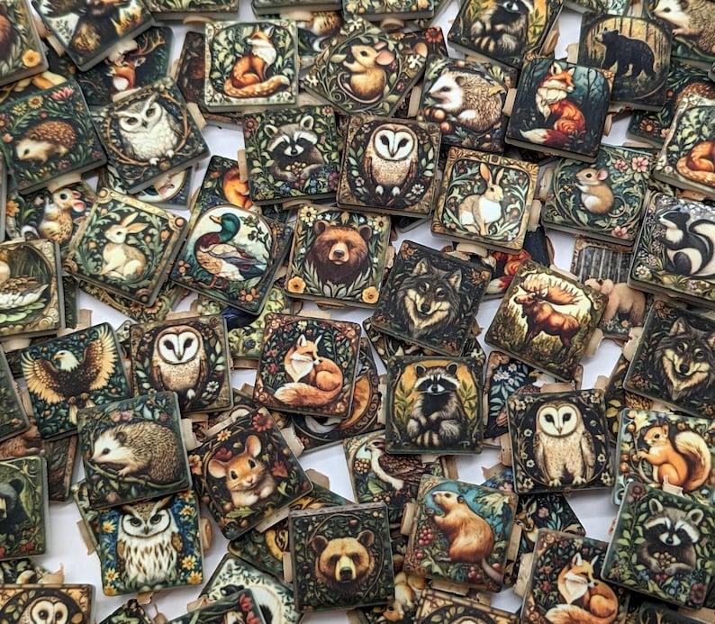 May include: A collection of square wooden tiles featuring various forest animals such as owls, foxes, and bears. Each tile has a detailed illustration with a vintage aesthetic, surrounded by floral and leaf borders. The color palette includes greens, browns, and creams.