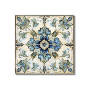 May include: Square framed artwork featuring a symmetrical floral design in shades of blue, green, and cream. The artwork has a detailed, ornate pattern with a central flower and surrounding stylized leaves. The frame is a light gold color.