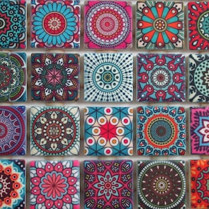 May include: A set of 16 colorful square ceramic tiles with intricate mandala designs. Each tile features a different pattern in shades of blue, red, pink, green, and white.