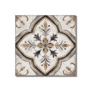 May include: Square decorative tile with a floral pattern. The design features a central flower with surrounding leaf motifs in shades of brown, black, and gray, set against a cream-colored background. The tile has a distressed, aged appearance.