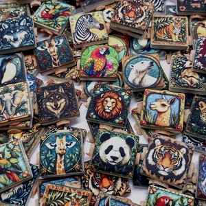 May include: A collection of square wooden clips featuring colorful illustrations of various animals including tigers, wolves, lions, pandas, giraffes, zebras, parrots, elephants, and polar bears, arranged in a dense, overlapping pile.