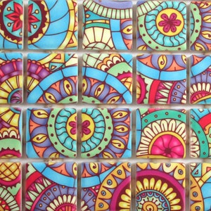 May include: A set of 12 colorful ceramic tiles with intricate mandala designs. Each tile features a unique pattern with a mix of blue, green, red, yellow, and purple hues.