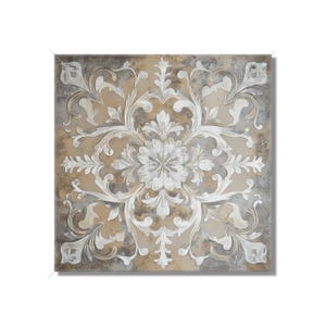 May include: Square wall art featuring a symmetrical floral design in white against a neutral background. The artwork has a distressed, textured appearance with a mix of gray, beige, and off-white tones, creating a vintage aesthetic.