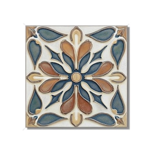 May include: A square ceramic tile with a blue, brown, and white floral design. The tile has a raised, textured surface.