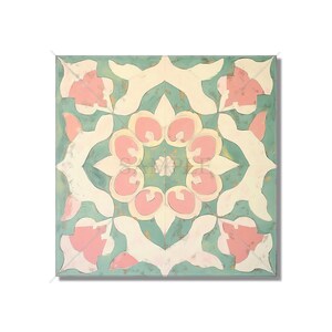 May include: Square decorative tile with a symmetrical floral design. The tile features a teal background with white, pink, and gold accents. The central design is a pink flower surrounded by white and teal shapes.