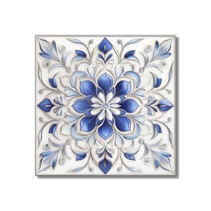 May include: A square tile with a blue and white floral design. The tile has a white background with a blue floral pattern in the center. The floral pattern is surrounded by a silver border.