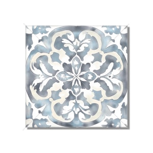 May include: A square tile with a white background and a blue and white floral pattern. The pattern is symmetrical and has a central flower with four petals.