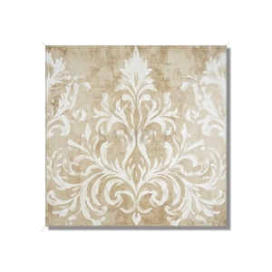 May include: Square canvas art featuring a cream-colored, ornate damask pattern against a textured, tan background. The design is symmetrical, with a central motif and repeating elements.