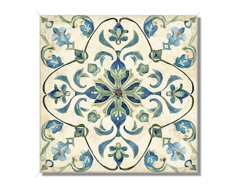 Op de afbeelding: Een vierkante tegel met een blauw en groen bloemenpatroon. De tegel heeft een witte achtergrond en een bruin centrum.