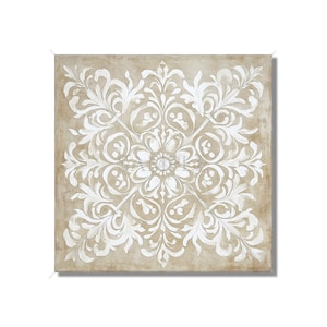 May include: Square canvas art featuring a symmetrical white floral design on a beige background. The design is a detailed, stylized floral pattern with a central flower and surrounding leaf and swirl motifs. The artwork has a vintage, textured appearance.