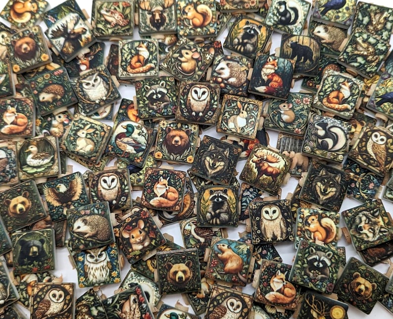 May include: A collection of small, square wooden tiles with detailed illustrations of woodland animals, including foxes, owls, bears, and raccoons. The tiles feature a vintage, botanical style with earthy tones and intricate floral borders.