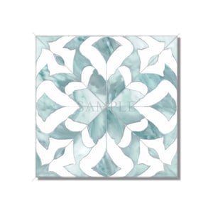 May include: A square tile with a white and teal blue geometric pattern. The pattern is symmetrical and features a floral design.