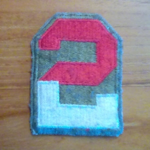 May include: A red and green felt patch with the number 2 embroidered on it. The number is outlined in white.