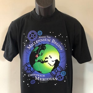 May include: Black t-shirt with a graphic of a green globe with the text "Where the Millennium Begins Greenwich Meridian".