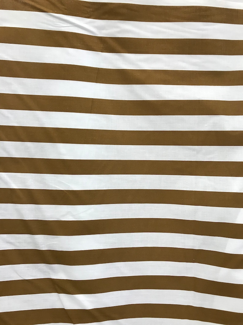 May include: Brown and white striped fabric with a subtle texture. The fabric is folded and has a slight wrinkle.