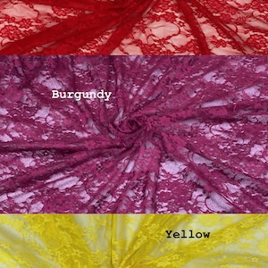 May include: Three swatches of floral lace fabric arranged in horizontal panels. The top panel is red, the middle panel is burgundy, and the bottom panel is yellow. Each section features a delicate, intricate floral pattern with openwork.