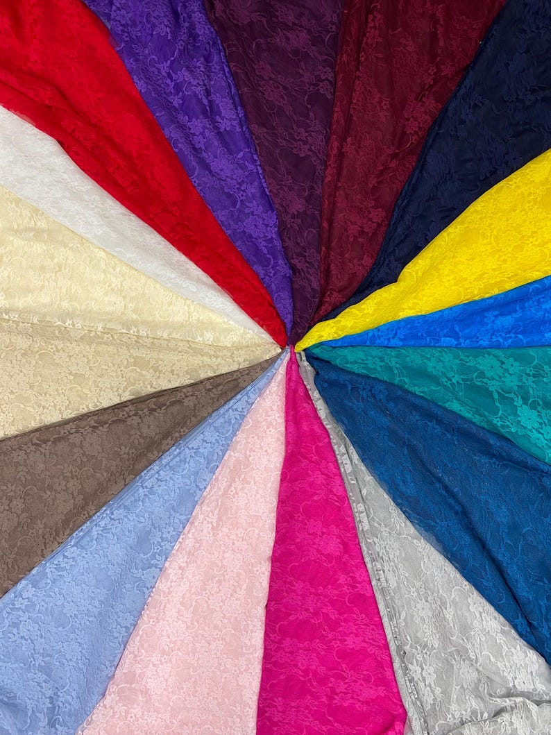 May include: A collection of lace fabric swatches arranged in a circular fan pattern, featuring a variety of colors including red, purple, dark burgundy, navy blue, yellow, teal, royal blue, gray, hot pink, light pink, blue, brown, cream, and white.
