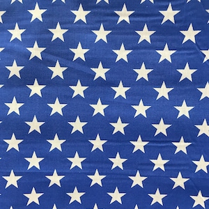 May include: Blue fabric with a repeating pattern of white stars.