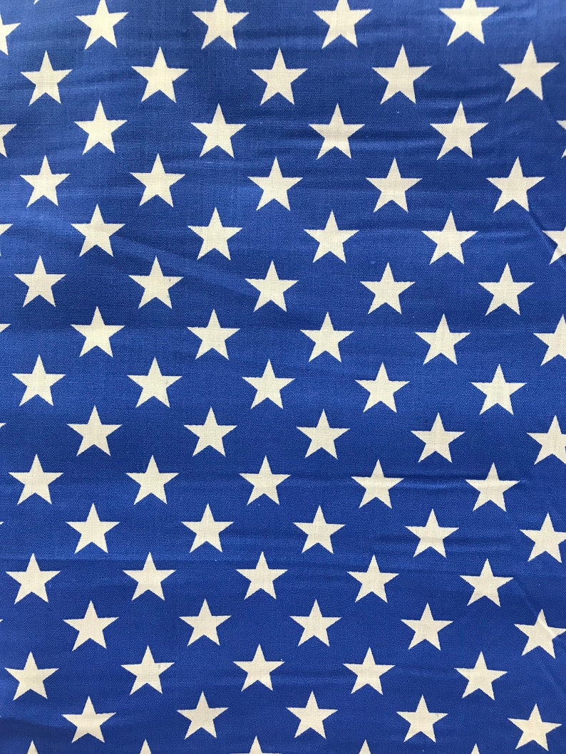 May include: Blue fabric with a repeating pattern of white stars.